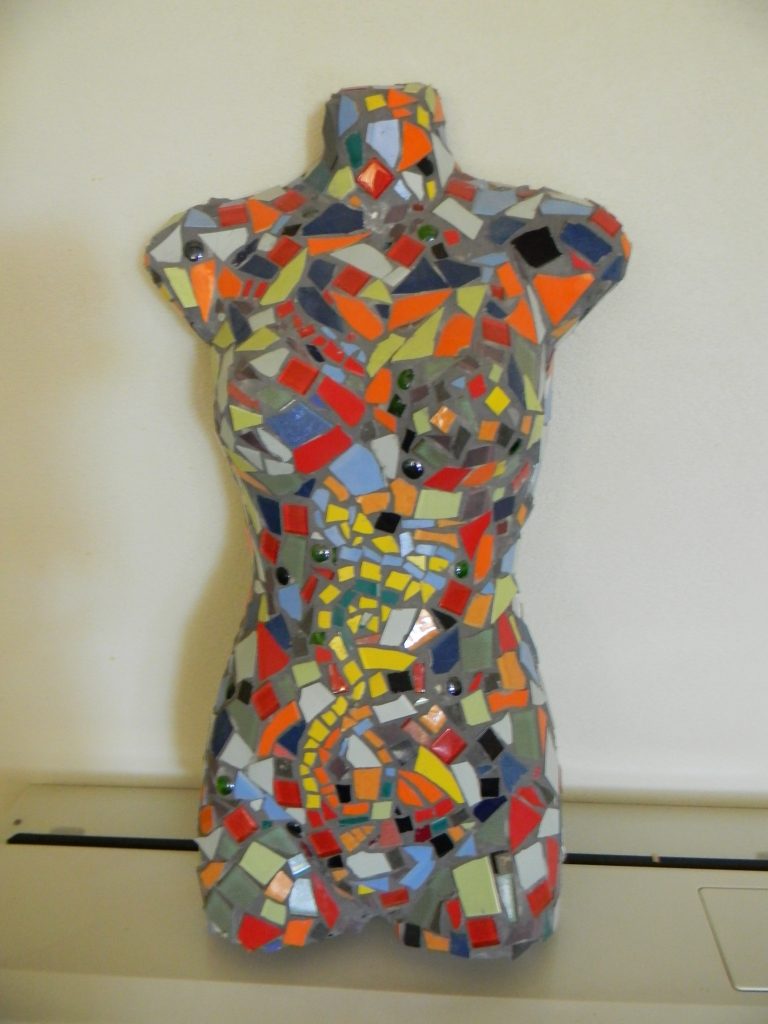 Feminine mosaic on display in the garden